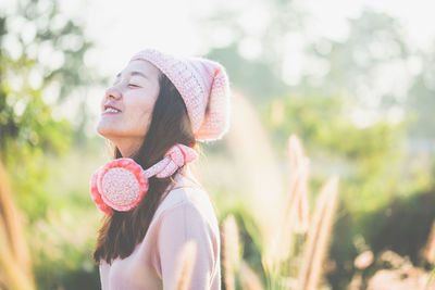 Smiling young woman wearing warm clothes outdoors