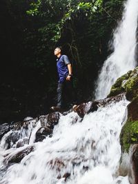 Low angle view of man standing on water