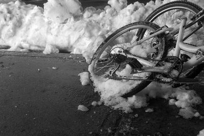 High angle view of abandoned bicycle on snow covered land