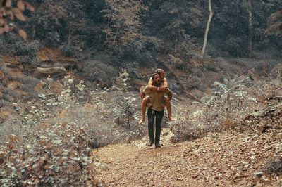 Full length of man standing in forest