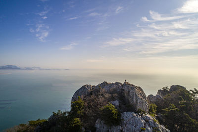 Rock formations by sea against sky