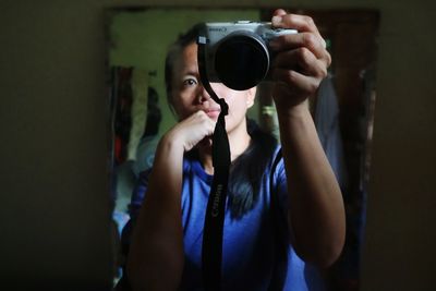 Portrait of woman photographing