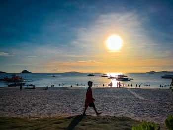 Scenic view of beach against sky during sunset