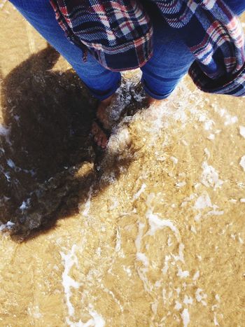 High angle view of woman standing in water on beach