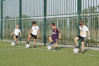 Group of people playing soccer on field