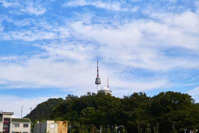 Distant view of n seoul tower against cloudy sky