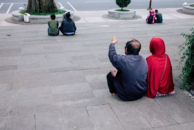 Rear view of men sitting outdoors