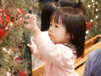 Rear view of woman looking at christmas tree