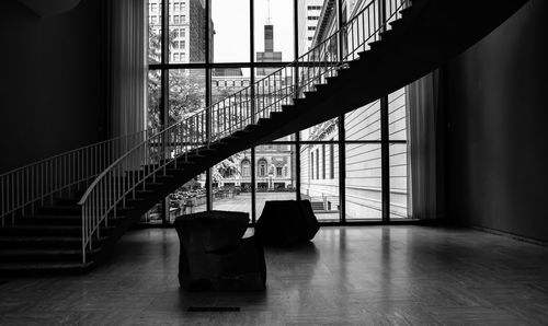 Large empty winding staircase against the city skyline