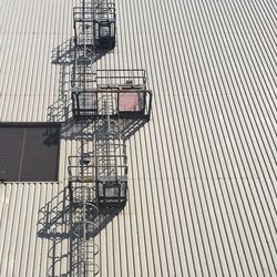 Low angle view of ladder on industrial building