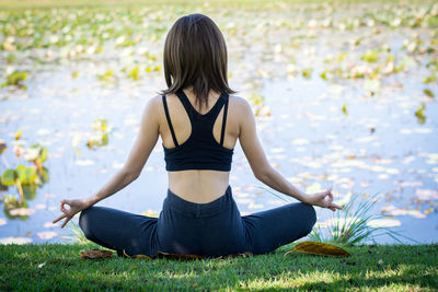 Rear view of woman sitting outdoors
