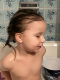 Portrait of shirtless boy in bathroom at home