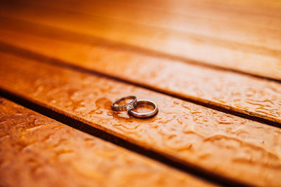 Close-up of wedding rings on table