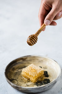 Close-up of hand holding ice cream on table