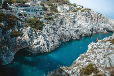 High angle view of rocks on sea shore