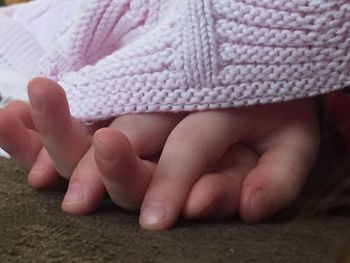 Low section of baby feet on rug