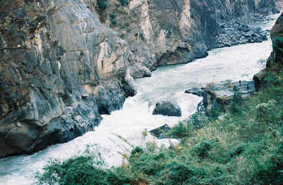 High angle view of water flowing through rocks