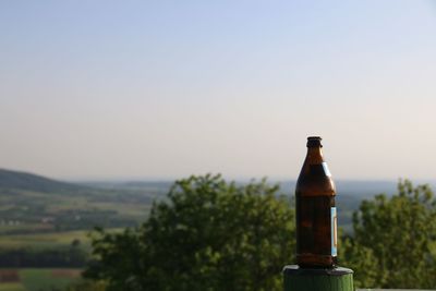 Close-up of beer bottle against clear sky