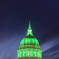 Low angle view of illuminated building against sky at night