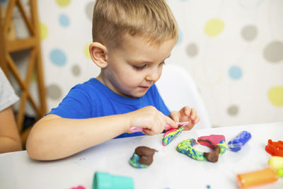 Close-up of boy playing with toys at home