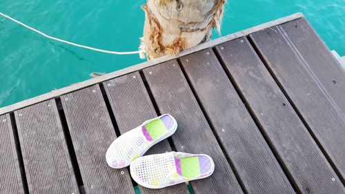 High angle view of deck chairs by swimming pool