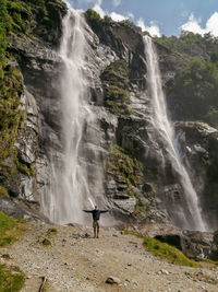 Scenic view of man and waterfalls