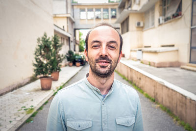 Portrait of smiling man standing in city