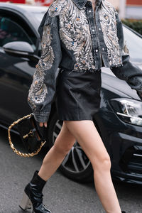 Low section of woman standing on street