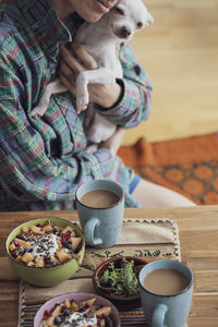 Midsection of man holding coffee cup