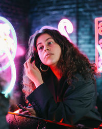 Portrait of young woman while sitting at restaurant