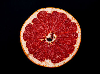Close-up of fruit slices against black background