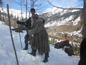 Man standing on snow covered landscape during winter