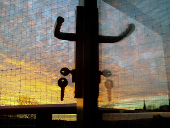 Close-up of buddha statue against window