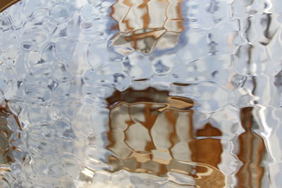 Low section of reflection of glass in swimming pool