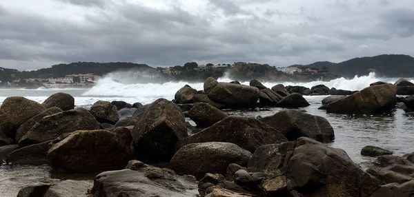 Scenic view of rocks in sea against sky