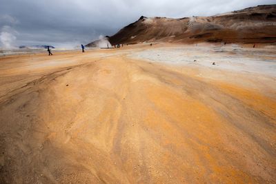 Surface level of calm beach against the sky