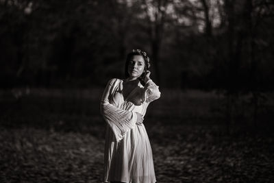 Portrait of woman standing on field