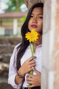 Portrait of beautiful woman holding flowers