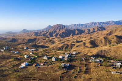 Panoramic view of landscape and mountains against clear blue sky