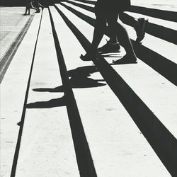 Low section of woman standing on tiled floor