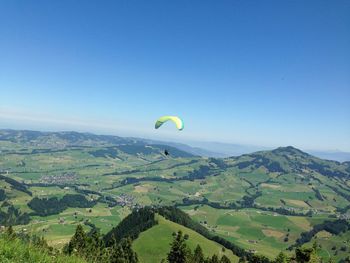 Hot air balloons flying over landscape