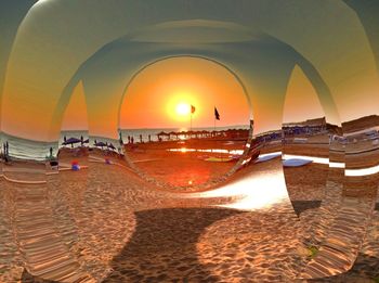 Scenic view of beach against clear sky during sunset