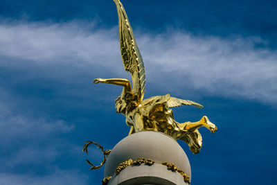 Low angle view of statue against blue sky