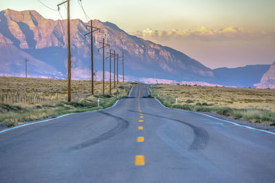 Road passing through landscape against sky