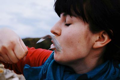 Close-up of fish slipping out of woman's hand