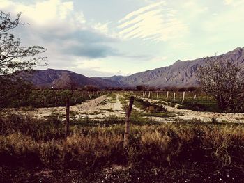 Scenic view of mountains against cloudy sky