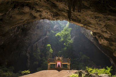 People on rock formation in cave