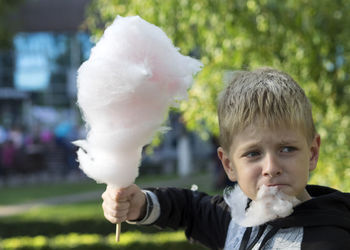 Close-up of boy eating cotton candy