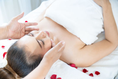 Midsection of woman lying on bed