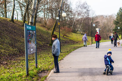 Rear view of people on footpath